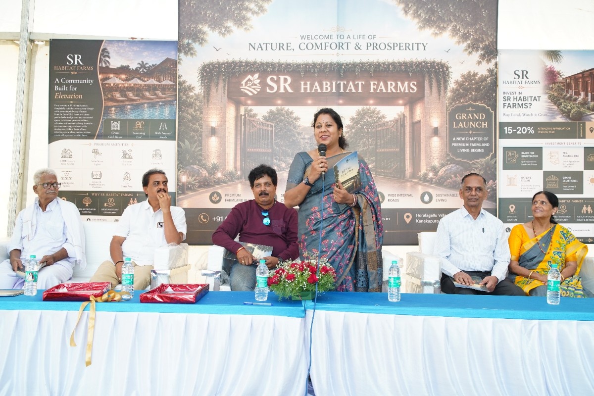 A speaker and seated guests at the Habitat Farms launch celebration